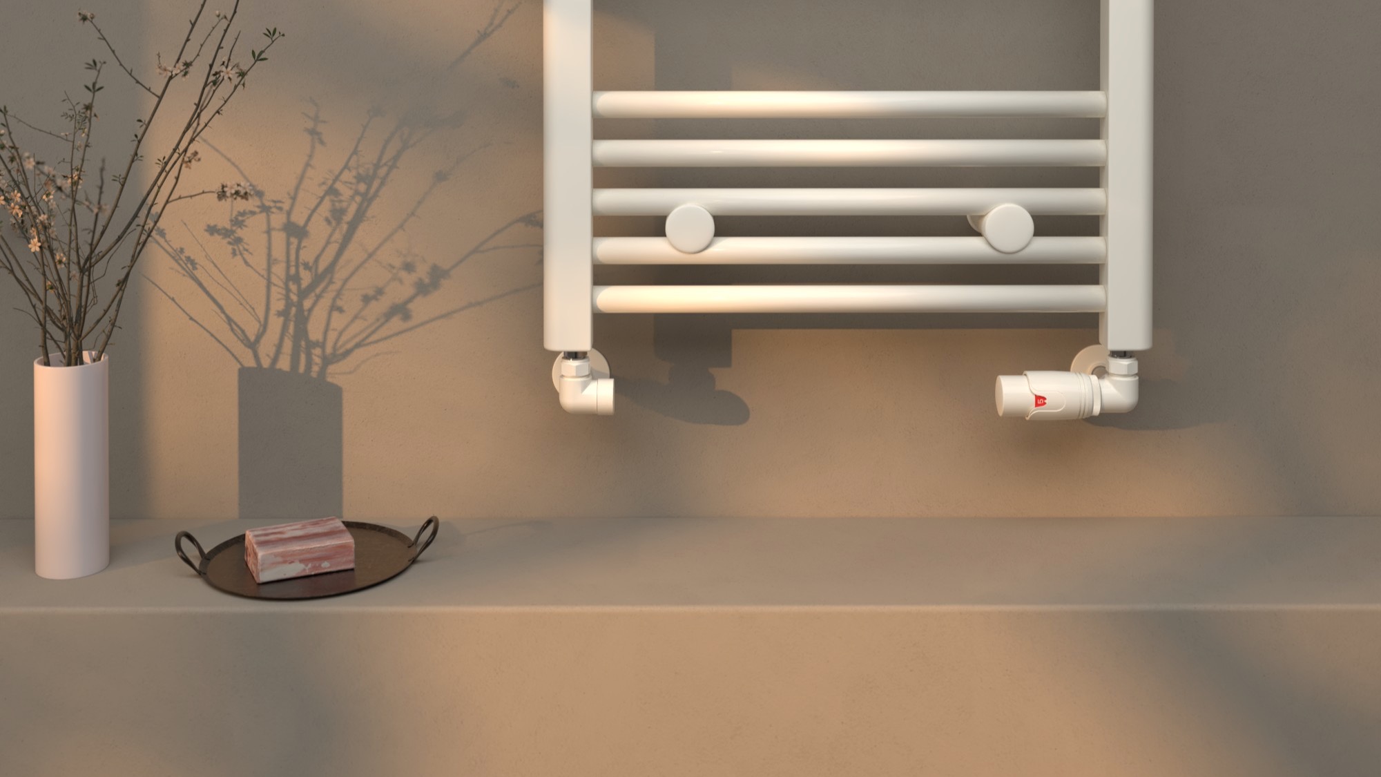 White heated towel rail with matching corner valves above a shelf with a vase, tray and decorative shadow.