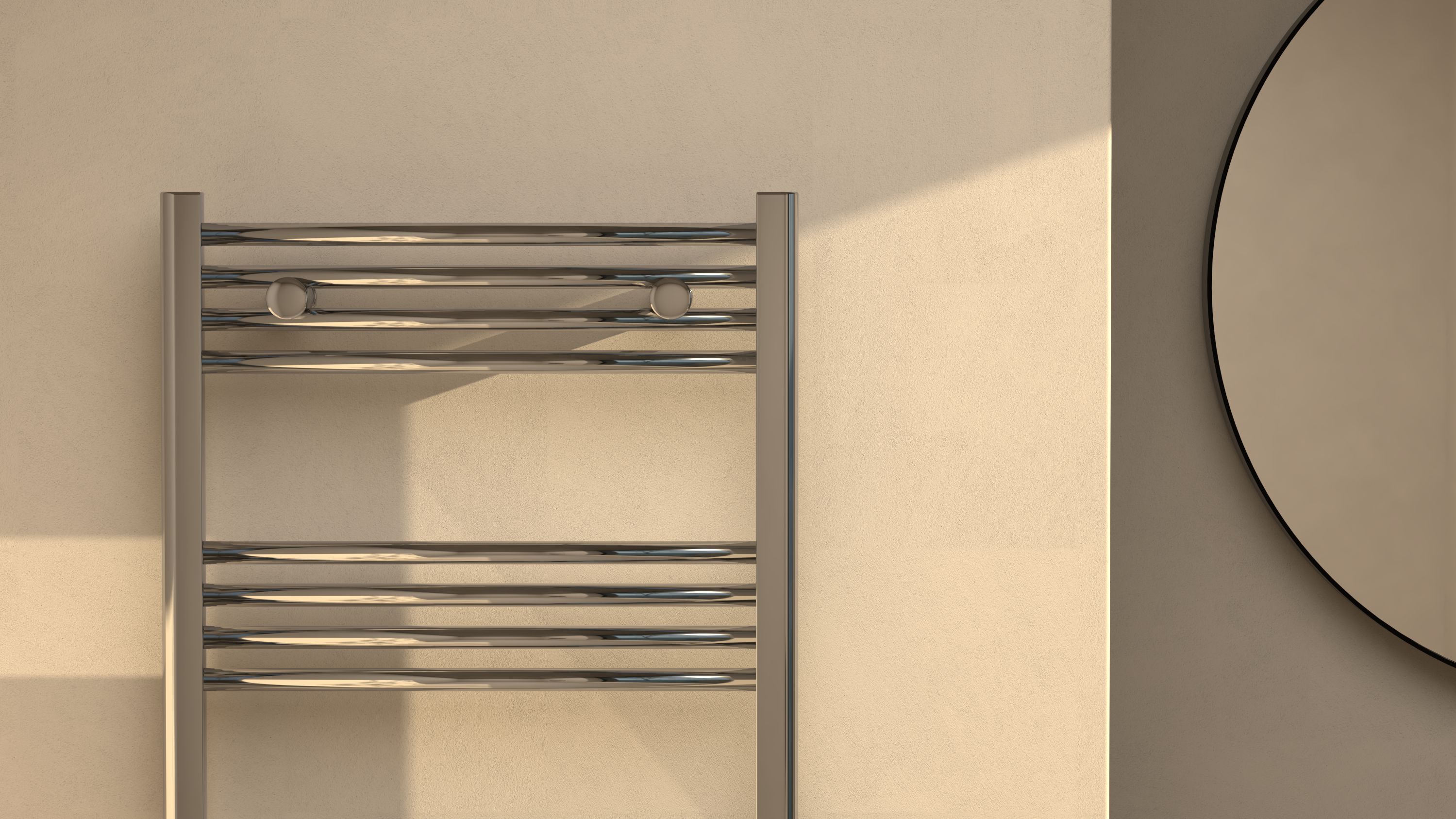 Close-up of a chrome heated towel rail beside a large round mirror on a sunlit textured wall.