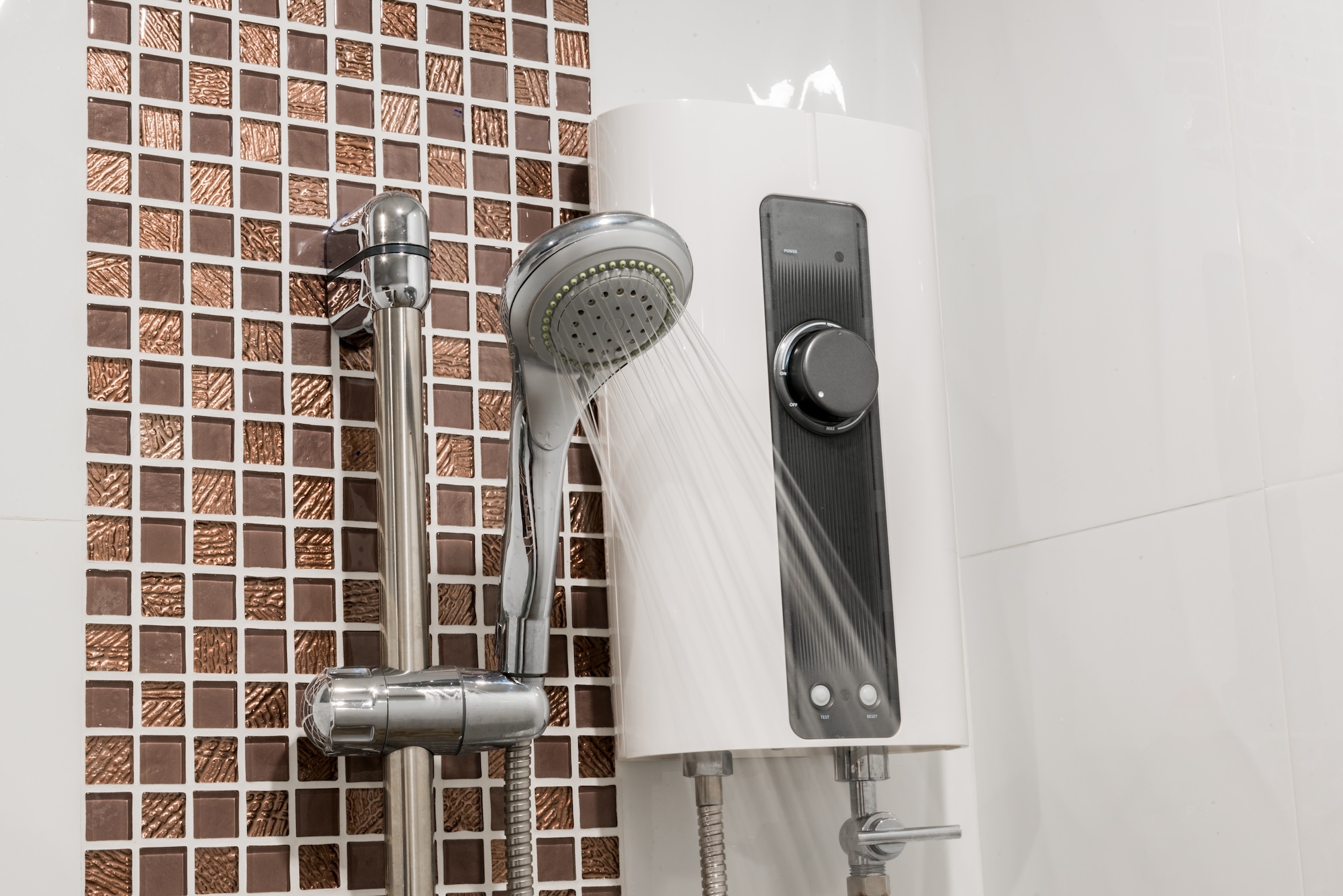 Electric shower unit with an adjustable temperature control and handheld shower head, delivering a steady flow of water during use.